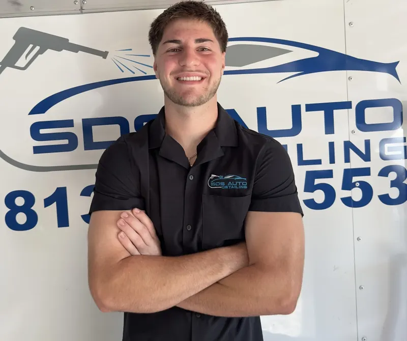 Noah Self, owner of SDS Auto Detailing, in front of the mobile detailing trailer